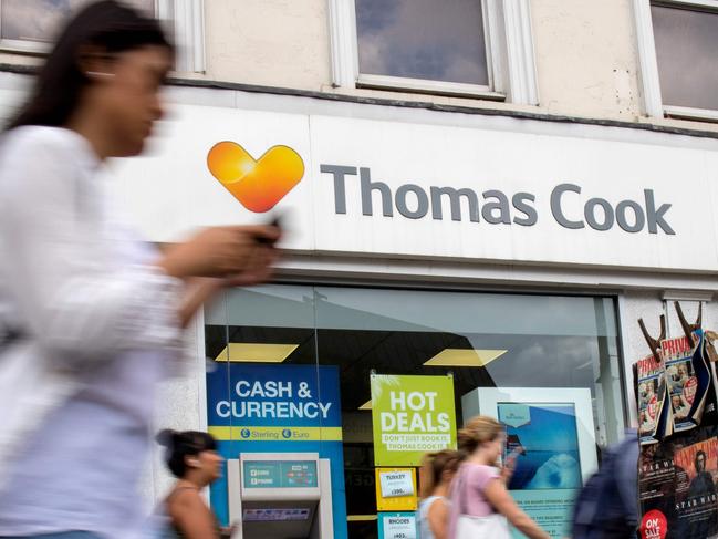 (FILES) In this file photo taken on July 12, 2019 Pedestrians are pictured walking past a branch of a Thomas Cook travel agent's shop in London. - Iconic British travel firm Thomas Cook has failed to find further private investment to stave off collapse and is now relying on an unlikely government bailout, a source close the matter told AFP on September 21, 2019. The operator said Friday that it needed £200 million ($250 million, 227 million euros) -- in addition to the £900-million rescue deal secured last month -- or else face administration, which could potentially trigger Britain's largest repatriation since World War II. (Photo by Tolga Akmen / AFP)