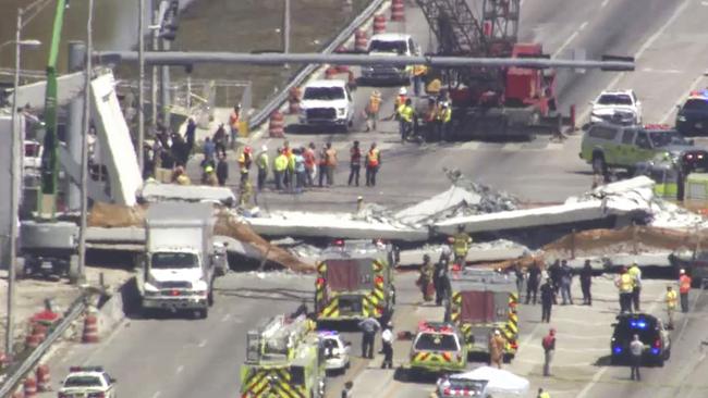 In this frame from video, emergency personnel work at the scene of a collapsed bridge in the Miami area, Thursday, March 15, 2018. (WPLG-TV via AP)