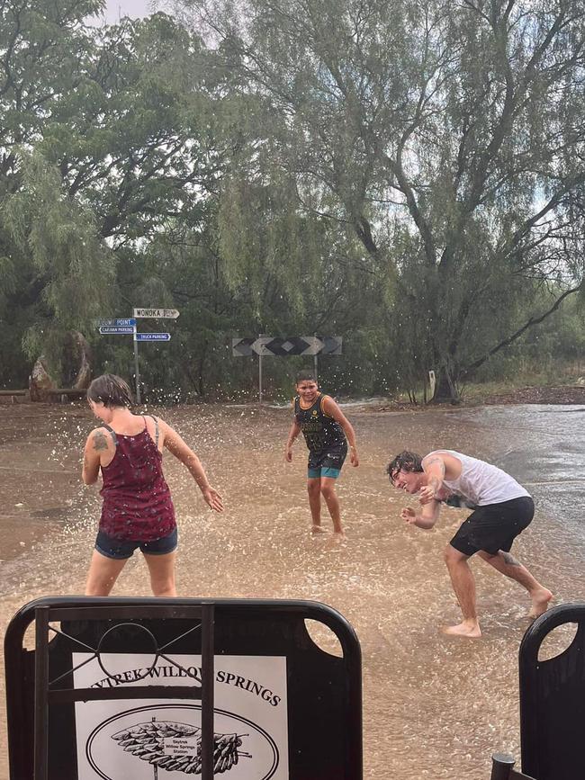 Hawker Hotel Motel patrons have fun in the summer rain on Monday. Picture: Hawker Hotel Motel