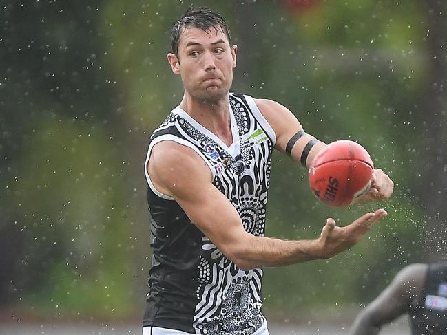 Palmerston skipper Matt Dennis fires out a handpass in the game on Bathurst Island. Picture: Felicity Elliott AFLNT/Media