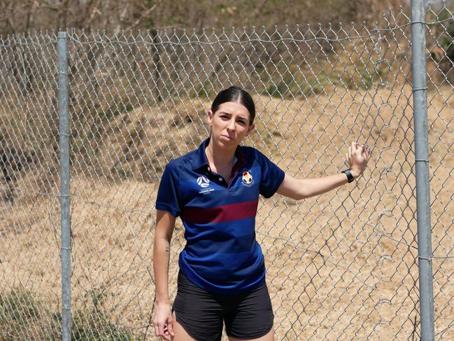 MA Olympic Football Club player Monique Sullivan pulls on the repaired fence that was cut. Picture: Blair Jackson