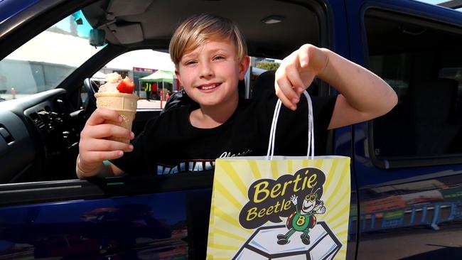 Cooper Smith, 9, Enjoying a Strawberry Sundae and a Bertie Beetle Showbag. Picture David Clark