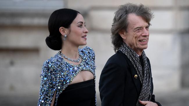 English singer Mick Jagger and his partner US choreographer Melanie Hamrick. (Photo by Daniel LEAL / AFP)