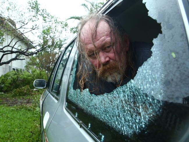 Steven Andrew, 56, with some of the damage Cyclone Debbie caused in Airlie Beach. Photographer: Liam Kidston