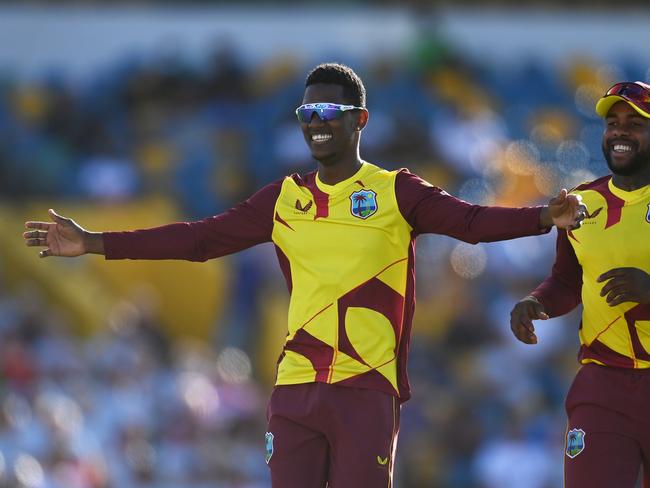 BRIDGETOWN, BARBADOS - JANUARY 22: Akeal Hosein of West Indies celebrates the wicket of Sam Billings of England during the T20 International Series First T20I match between West Indies and England at Kensington Oval on January 22, 2022 in Bridgetown, Barbados. (Photo by Gareth Copley/Getty Images)