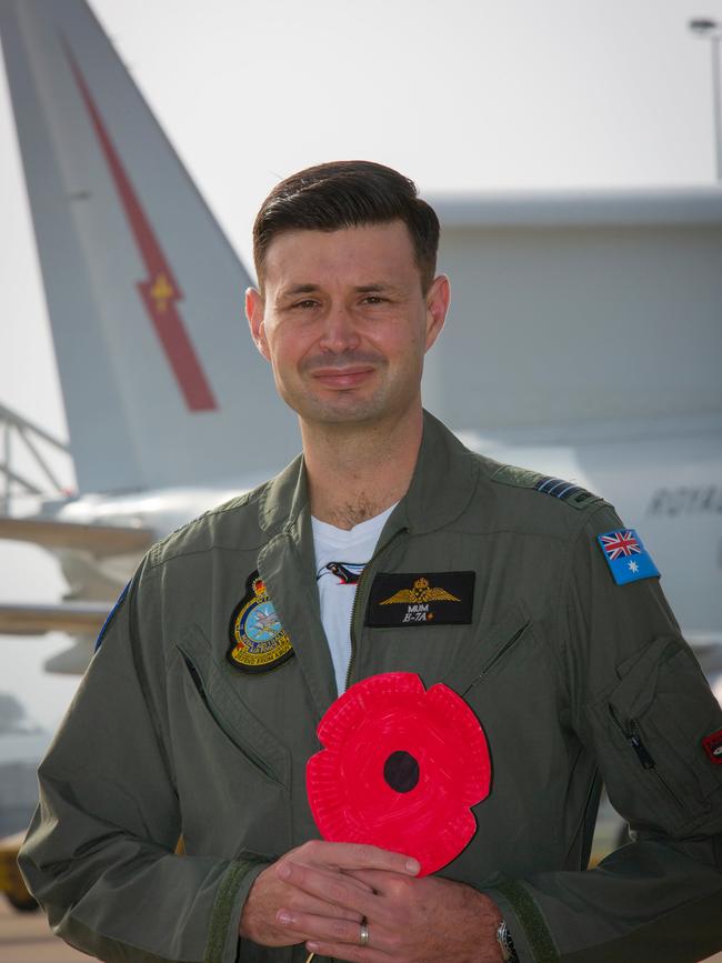 Squadron Leader Darrin Lindsay, an Air Battle Manager at No. 42 Wing, Royal Australian Air Force Base Williamtown, NSW, holds a poppy he made with his daughter which will be displayed in his front yard to commemorate ANZAC DAY 2020. Picture: ADF