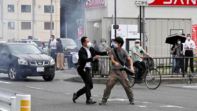 A security officer seizes suspect Tetsuya Yamagami in the shooting of former Japan PM Shinzo Abe.