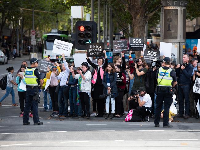 Animal rights protesters are seen at the intersection of Flinders and Swanston Street, in Melbourne. Picture: AAP Image/Ellen Smith