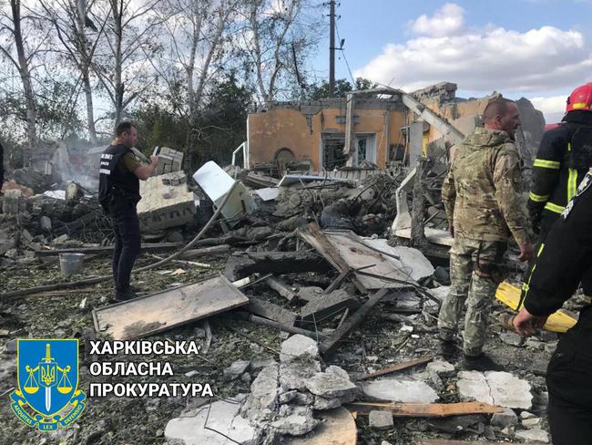 Rescuers working on debris at a destroyed shop after a Russian strike in the village of Groza, some 30 kilometres west of Kupiansk. Picture: Supplied