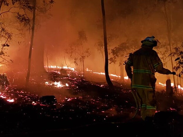 Firefighters working overnight at the scene of an out-of-control bushfire at Terragon, near Uki, northern New South Wales.