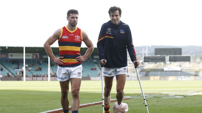 LAUNCESTON, AUSTRALIA – APRIL 25: Will Hamill of the Crows (R) is seen on crutches after the round six AFL match between the Hawthorn Hawks and the Adelaide Crows at University of Tasmania Stadium on April 25, 2021 in Launceston, Australia. (Photo by Daniel Pockett/Getty Images)