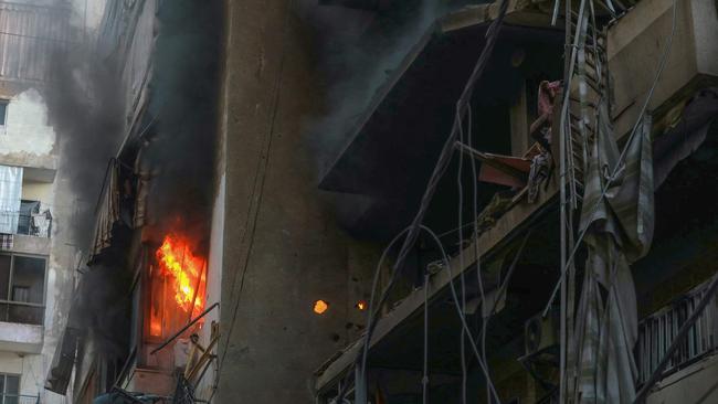 A fire burns in a damaged building at the site of overnight Israeli airstrikes on the Chiah neighbourhood in Beirut's southern suburbs on Friday. Picture: AFP