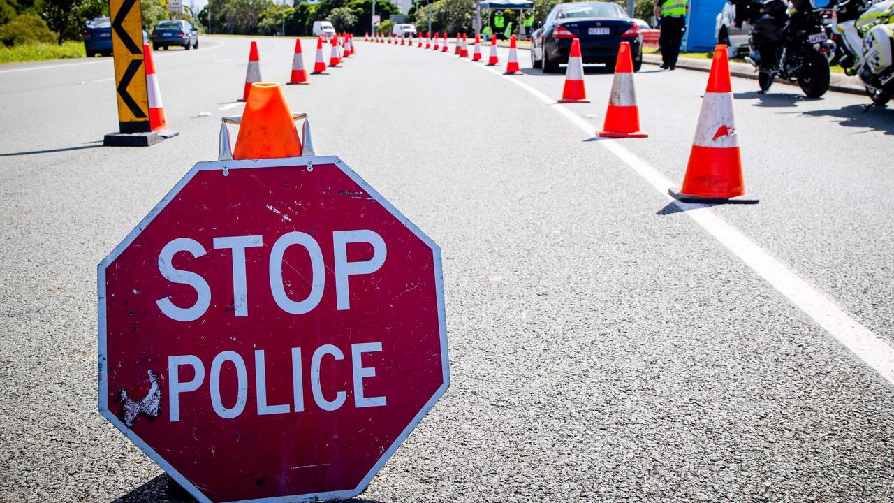 A vehicle checkpoint on the Pacific Highway on the Queensland - New South Wales border.(Photo by Patrick HAMILTON / AFP)