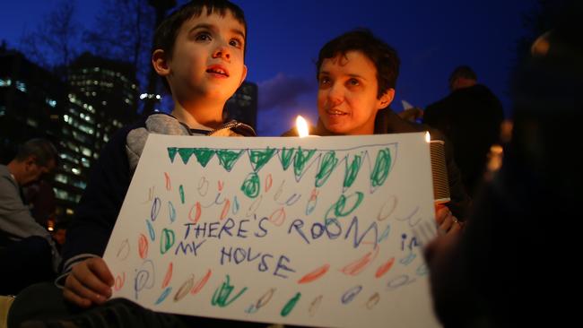 An Australian boy holds a sign reading ‘There’s room in my house’ in support of the government expanding our refugees intake. (Photo by Daniel Munoz/Getty Images)