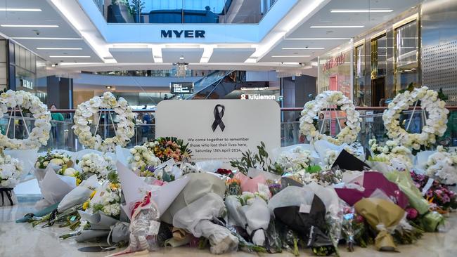 Flowers are displayed at a memorial set up inside the Bondi Junction Westfield Shopping Centre. Picture: Ayush Kumar / AFP