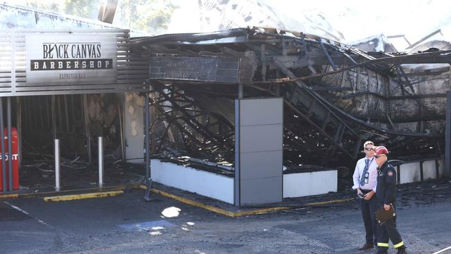 Police and firefighters at the scene of the fire at Windaroo. Picture: Peter Wallis