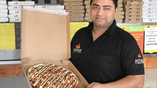 Pizzatude owner Andy Gulati with his best-selling Paneer Tikka pizza.