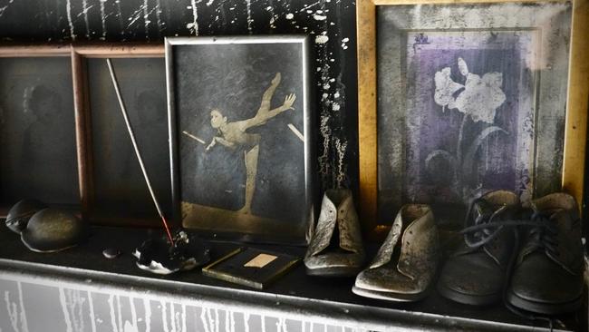 Kathy McMorrow’s flood savaged treasures, including photos from her time as a gymnast, were later damaged by smoke. Picture: Mo McMorrow.