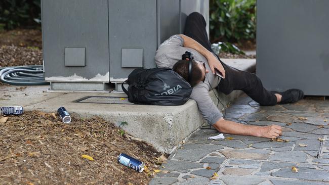 A drunk man sleeps in the Shields Street Mall. Picture: Brendan Radke