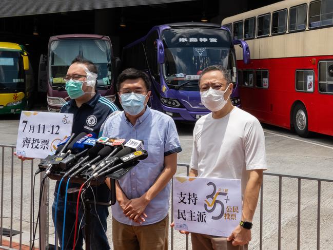 Andrew Chiu Ka-yin (L), Au Nok-hin (C) and Benny Tai (R) speak outside a temporary polling station during a primary election. China says Hong Kong is plotting revolution. Picture: Getty Images