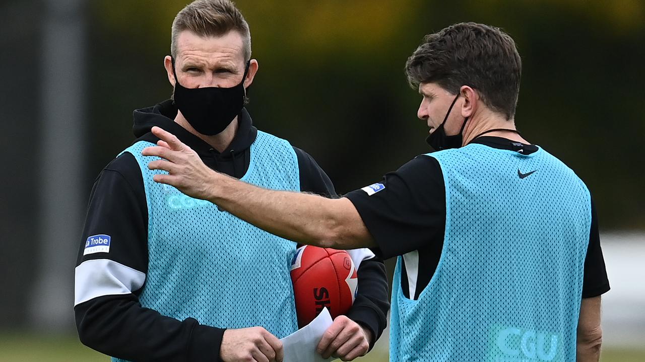 Pie coaches Nathan Buckley and Robert Harvey don masks at training as they prepare to fly in to Adelaide. Picture: Getty Images