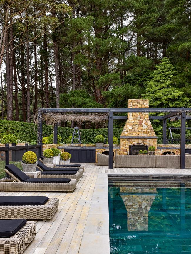 The pool and oversized outdoor fireplace overlooks the gardens designed by friend and landscape architect Paul Bangay. Picture: Derek Swalwell