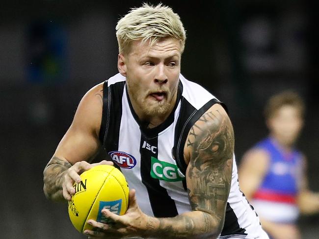 MELBOURNE, AUSTRALIA - MARCH 20: Jordan De Goey of the Magpies is tackled by Josh Dunkley of the Bulldogs during the 2020 AFL Round 01 match between the Western Bulldogs and the Collingwood Magpies at Marvel Stadium on March 20, 2020 in Melbourne, Australia. (Photo by Michael Willson/AFL Photos via Getty Images)