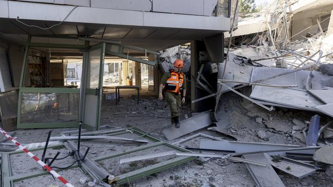 An emergency responder inspects damage of a school in Tel Aviv after a rocket strike from fired from Yemen, on Thursday. Picture: getty Images