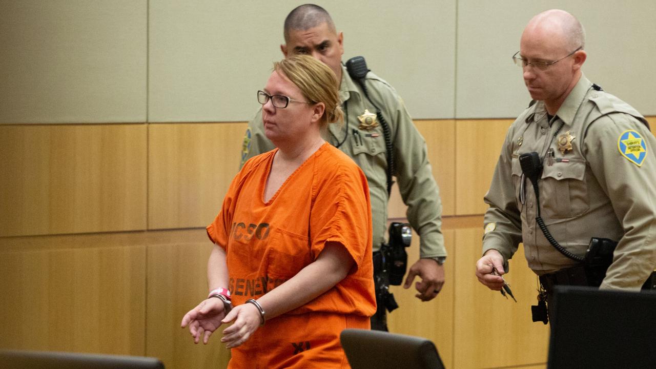 Lisa Cunningham is escorted back to a holding cell by Maricopa County Sheriff's officers at the Superior Court of Arizona. Picture: Caitlin O'Hara