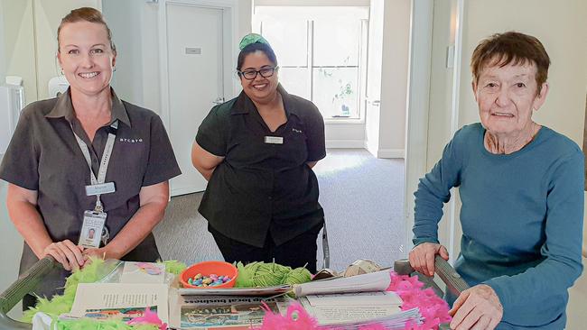 Arcare North Lakes staff Maree Katic and Catherine Neubauer provide activities for resident Irene Strong.