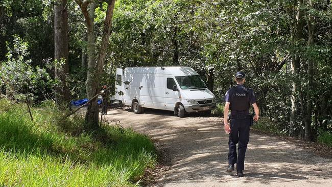 HUNT: Police guard Burns Rd at Ross Creek near Gympie where detectives are scouring for clues after the body of a man was found in ditch on a property. Photo: Frances Klein