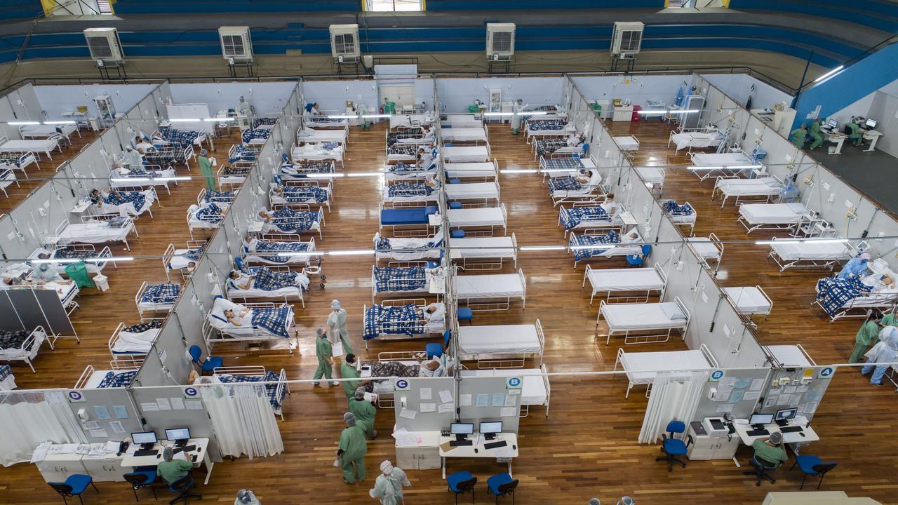 Coronavirus patients lie on beds in a field hospital built inside a gym in Santo Andre, on the outskirts of Sao Paulo, Brazil. Picture: Andre Penner