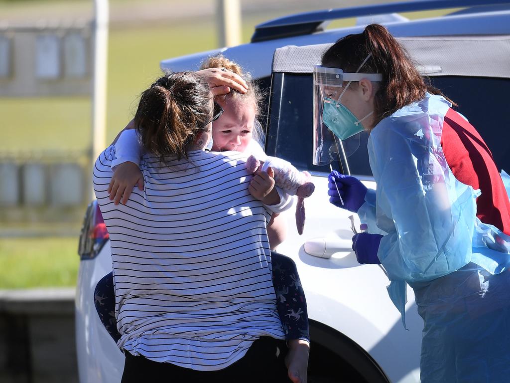 A health worker attempts to swab an unhappy toddler at a pop up Covid-19 testing clinic in Toowong, Brisbane, as Queensland battles through a Delta variant outbreak of coronavirus.Picture: NCA NewsWire / Dan Peled