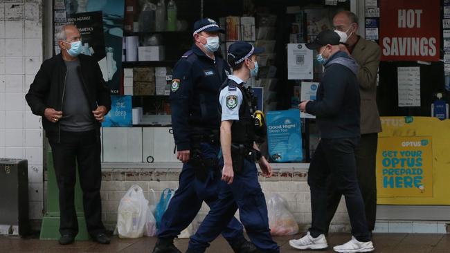 Police officers moving through the shopping district at Fairfield on Friday. Picture: Getty