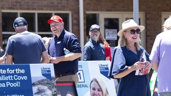 Labor Candidate Alex Dighton and Liberal Candidate Amanda Wilson speak to people voting in the Black by-election on November 12. Picture: Brett Hartwig.