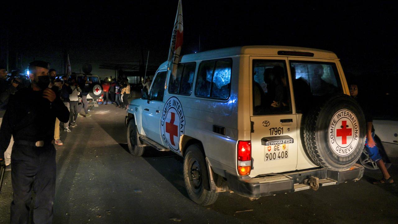 International Red Cross vehicles reportedly carrying Israeli hostages released by Hamas cross the Rafah border point in the Gaza Strip on the way to Egypt. Picture: AFP