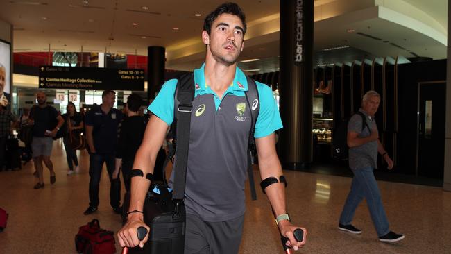 Mitchell Starc arrives at Sydney Airport on crutches. Picture: Jane Dempster