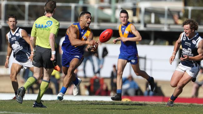 Deer Park's Kwame McHarg fires off a handball. Picture: Local Legends Photography