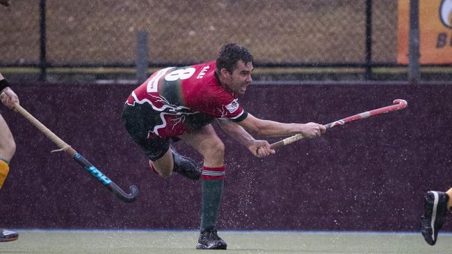 The intensity of the rain is emphasised in this shot of Redcliffe’s Kyle Murphy, with water running of his stick. Picture: Renae Droop