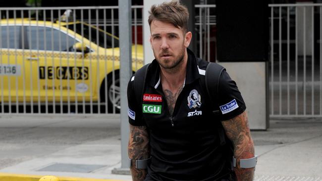 Dane Swan arrives back at Melbourne Airport after suffering a fractured fibula and foot in Collingwood's loss to Sydney yesterday. Picture: Andrew Henshaw