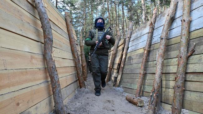 Ukrainian servicemen walk near Kharkiv. Ukraine has spent eight years to build trenches, fortifications and other defensive positions. Picture: AFP