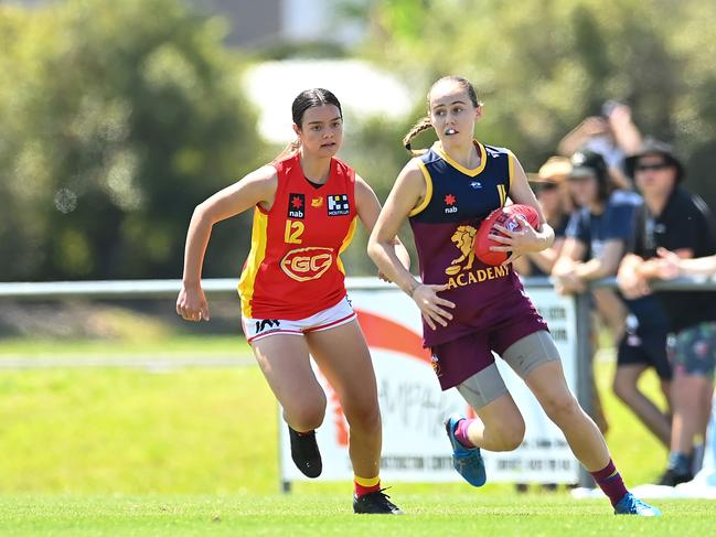 Mia Geere of the Lions handles the ball in front of Evy Reeves of the Suns during the AFL U16 Girls match between the Brisbane Lions and the Gold Coast Suns on September 19, 2022 in Sunshine Coast, Australia. Picture: Albert Perez/AFL Photos via Getty Images