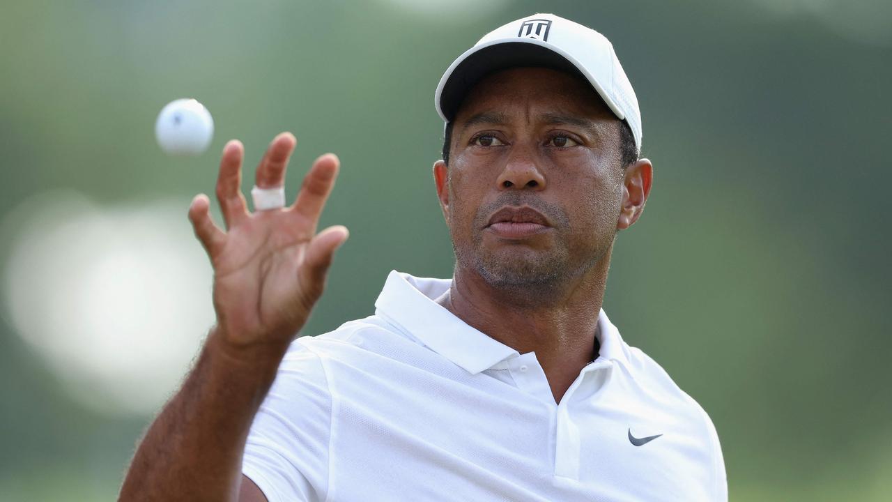 (FILES) In this file photo taken on May 17, 2022, Tiger Woods catches a ball during a practice round prior to the start of the 2022 PGA Championship at Southern Hills Country Club in Tulsa, Oklahoma. - Woods announced on June 7, 2022, that he will not play next week's US Open at Brookline to continue his recovery from severe leg injuries sustained in a car accident last year. The 15-time major champion withdrew from the PGA Championship last month after the third round. (Photo by Christian Petersen / GETTY IMAGES NORTH AMERICA / AFP)