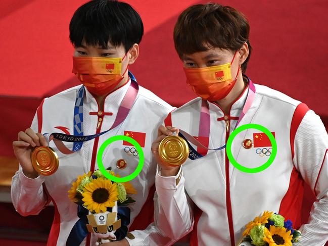 Gold medallists China's Bao Shanju (L) and China's Zhong Tianshi pose with their medals on the podium after the women's track cycling team sprint finals during the Tokyo 2020 Olympic Games at Izu Velodrome in Izu, Japan, on August 2, 2021. (Photo by Greg Baker / AFP)