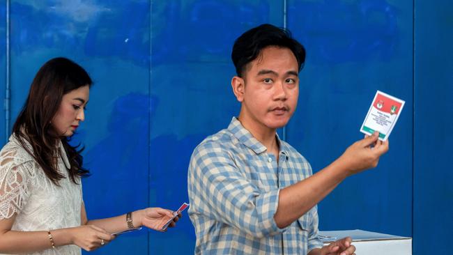 Indonesian Vice-President Gibran Rakabuming Raka and his wife Selvi Ananda show their ballot papers in Solo, central Java. Picture: AFP