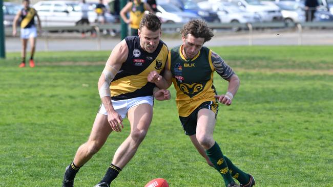 SPOS player Joseph Adamo battles Marion’s Dean Saunders in the division seven preliminary final last year. The Saints are now raging hot favourites for the flag. Picture: AAP/Keryn Stevens