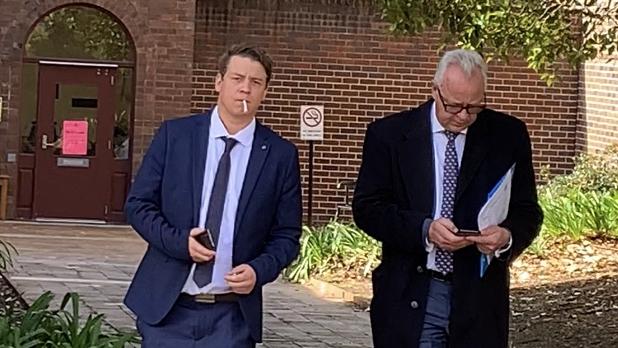 Alexander Hamblett (left) smokes while leaving court. Picture: Madelaine Wong