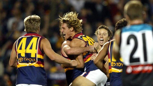 Luke Jericho celebrates a goal with teammates in the Crows’ upset win in Showdown 15 in 2004.