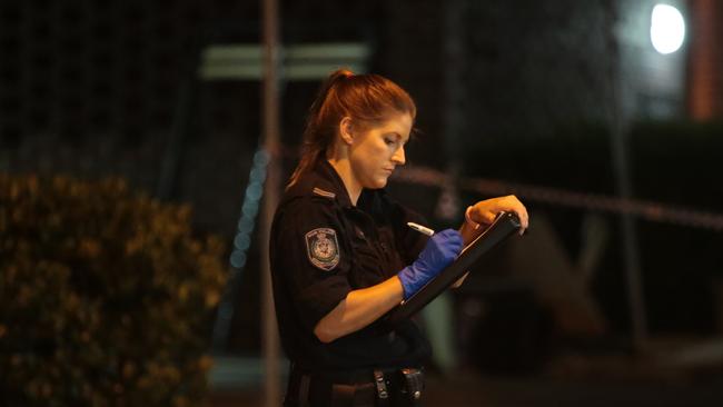 A police officer carries out the investigation. Picture: Damian Hoffman