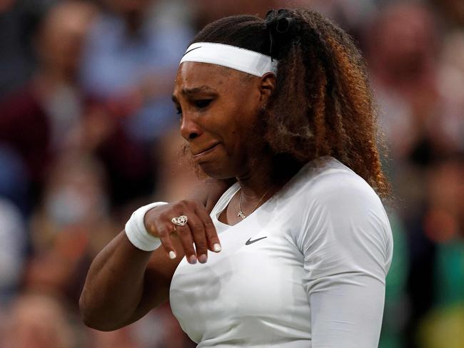 TOPSHOT - US player Serena Williams reacts as she withdraws from her women's singles first round match against Belarus's Aliaksandra Sasnovich on the second day of the 2021 Wimbledon Championships at The All England Tennis Club in Wimbledon, southwest London, on June 29, 2021. (Photo by Adrian DENNIS / AFP) / RESTRICTED TO EDITORIAL USE